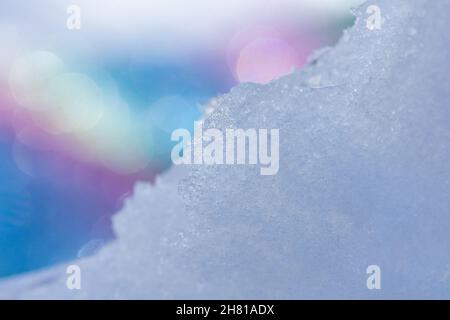 Winter ice on abstract blurred background. Ice frozen shined with sun bokeh. Stock Photo