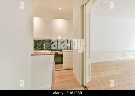 Corridor leading to the kitchen with a patterned wall Stock Photo