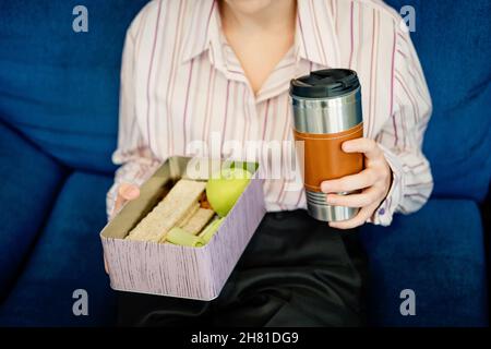 Meal Delivery Services, express Office Food Lunch Delivery. Young smiling business woman working at the office ordering delivery food, receiving order Stock Photo