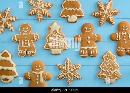 A variety of gingerbread cookies on a blue wooden background. View from above. Stock Photo