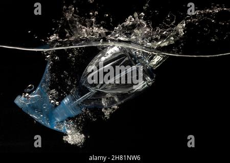 Hand sanitizer spray falls into the water causing large splashes  Stock Photo