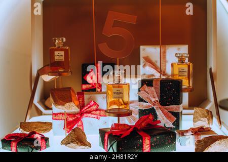 Gift stand of the famous Chanel perfume № 5. Luxury French brand for gifts for women. Golden background. Lux perfumery Stock Photo
