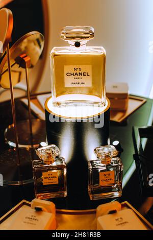 Golden glass bottle Chanel No. 5 perfume on the shop display, the first perfume launched by French couturier Gabrielle 'Coco' Chanel. Luxury perfumery Stock Photo