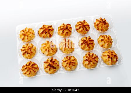 Healthy vegan Coconut cookies in plastic food tray for sale, isolated on white background Stock Photo
