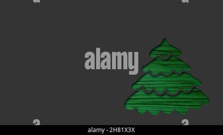 abstract christmas card with copy space - green christmas tree cut out from dark grey paper Stock Photo