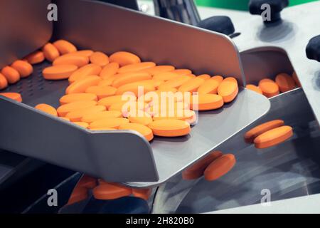 Pharmaceutical production line, production of tablets or vitamins manufacturing, tablet conveyor Stock Photo