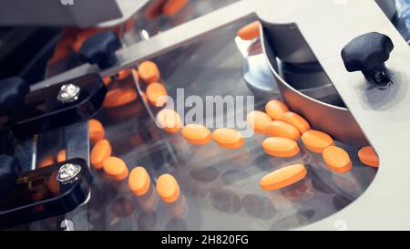 Pharmaceutical production line, production of tablets or vitamins manufacturing, tablet conveyor Stock Photo