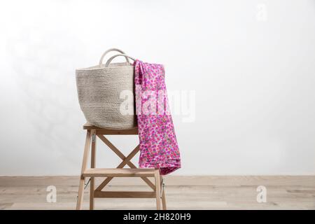 Large gray beach bag with a pink pareo woven from canvas on a beige ...