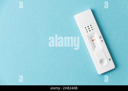 Negative rapid SARS-COV-2 antigen test card  on a blue background Stock Photo
