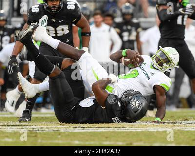 Orlando, FL, USA. 26th Nov, 2021. South Florida quarterback Timmy McClain (9) is sacked by Central Florida defensive lineman Big Kat Bryant (1) during 1st half NCAA football game between the USF Bulls and the UCF Knights at the Bounce House in Orlando, Fl. Romeo T Guzman/Cal Sport Media/Alamy Live News Stock Photo