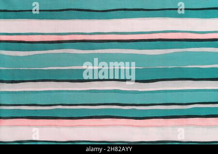 Striped fabric of teal and orange colors background. Texture of thin cotton cloth with alternation of light and dark horizontal lines. Colored textile Stock Photo