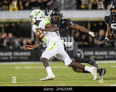 Orlando, FL, USA. 26th Nov, 2021. South Florida quarterback Timmy McClain (9) gets pressured from Central Florida defensive lineman Big Kat Bryant (1) during 2nd half NCAA football game between the USF Bulls and the UCF Knights. UCF defeated USF 17-13 at the Bounce House in Orlando, Fl. Romeo T Guzman/Cal Sport Media/Alamy Live News Stock Photo