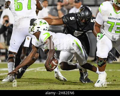 Orlando, FL, USA. 26th Nov, 2021. South Florida quarterback Timmy McClain (9) is sacked by Central Florida defensive lineman Ricky Barber (5) during 2nd half NCAA football game between the USF Bulls and the UCF Knights. UCF defeated USF 17-13 at the Bounce House in Orlando, Fl. Romeo T Guzman/Cal Sport Media/Alamy Live News Stock Photo