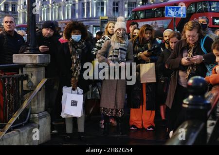 London, UK, 26th Nov, 2021, Passengers wait at the entrance to Oxford Circus Tube station as staff close-off the concourse due to overcrowding during a Trade Union strike. RMT Union members walked out in the first of seven Tube strikes in a dispute over staff rotas for the Night Tube, which resumes on the 27th November.  The first strike - on Black Friday seemingly didn't deter shoppers from travelling into the West End via the reduced service running at 60% of normal capacity. Credit: Eleventh Hour Photography/Alamy Live News Stock Photo