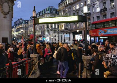London, UK, 26th Nov, 2021, Passengers wait at the entrance to Oxford Circus Tube station as staff close-off the concourse due to overcrowding during a Trade Union strike. RMT Union members walked out in the first of seven Tube strikes in a dispute over staff rotas for the Night Tube, which resumes on the 27th November.  The first strike - on Black Friday seemingly didn't deter shoppers from travelling into the West End via the reduced service running at 60% of normal capacity. Credit: Eleventh Hour Photography/Alamy Live News Stock Photo