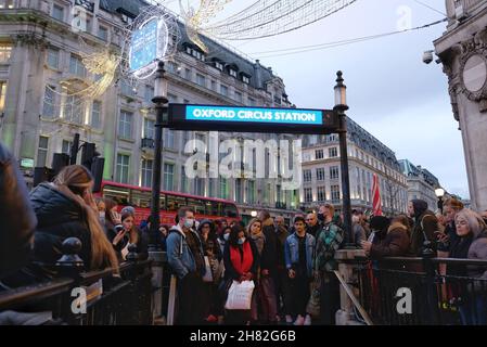 London, UK, 26th Nov, 2021, Passengers wait at the entrance to Oxford Circus Tube station as staff close-off the concourse due to overcrowding during a Trade Union strike. RMT Union members walked out in the first of seven Tube strikes in a dispute over staff rotas for the Night Tube, which resumes on the 27th November.  The first strike - on Black Friday seemingly didn't deter shoppers from travelling into the West End via the reduced service running at 60% of normal capacity. Credit: Eleventh Hour Photography/Alamy Live News Stock Photo
