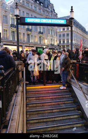 London, UK, 26th Nov, 2021, Passengers wait at the entrance to Oxford Circus Tube station as staff close-off the concourse due to overcrowding during a Trade Union strike. RMT Union members walked out in the first of seven Tube strikes in a dispute over staff rotas for the Night Tube, which resumes on the 27th November.  The first strike - on Black Friday seemingly didn't deter shoppers from travelling into the West End via the reduced service running at 60% of normal capacity. Credit: Eleventh Hour Photography/Alamy Live News Stock Photo