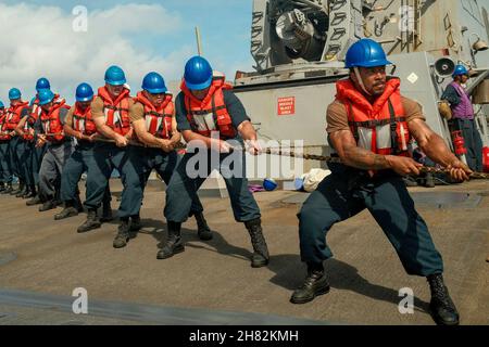 South China Sea. 17th Nov, 2021. Sailors aboard Arleigh Burke-class guided-missile destroyer USS Chafee (DDG 90) conduct line handling during a replenishment-at-sea with Henry J. Kaiser-class fleet replenishment oiler USNS Yukon (T-AO 202), Nov. 17, 2021. Chafee is on a scheduled deployment in the U.S. 7th Fleet area of operations to enhance interoperability through alliances and partnerships while serving as a ready-response force in support of a free and open Indo-Pacific region. Credit: U.S. Navy/ZUMA Press Wire Service/ZUMAPRESS.com/Alamy Live News Stock Photo