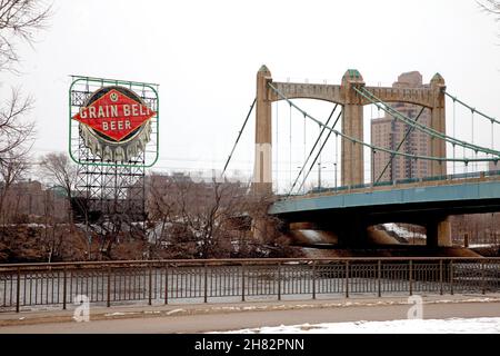 The iconic Grain Belt Beer sign next to the Hennepin Avenue Bridge and the Mississippi River. Minneapolis Minnesota MN USA Stock Photo