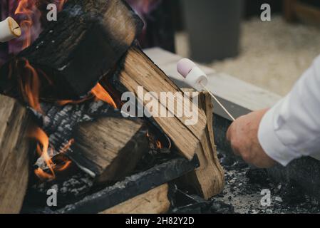 Toasting marshmallows on an open flame Stock Photo