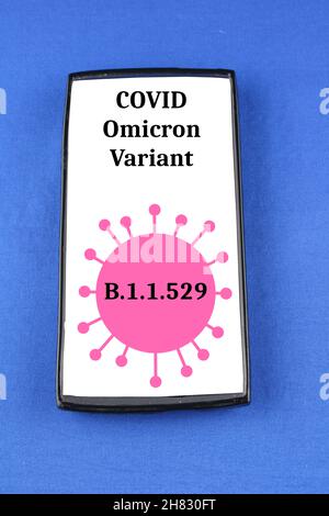 Covid Omicron Variant B11529 warning on a mobile phone isolated on a blue background Stock Photo