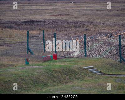 Rows of barbed wire on the state border. The separation of the two countries. Foggy autumn landscape  Stock Photo