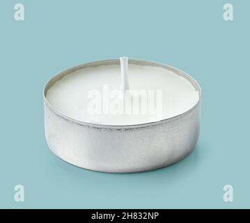 tea light candle isolated on blue background Stock Photo