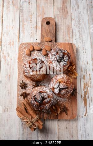 Baked apples with nuts and raisins. Homemade baked apples in the oven, with sugar powder close-up. Holiday dessert Stock Photo