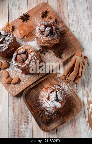 Baked apples with nuts and raisins. Homemade baked apples in the oven, with sugar powder close-up. Holiday dessert Stock Photo