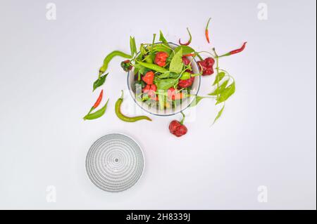 fresh colourful hot peppers on a wooden cutting board Stock Photo