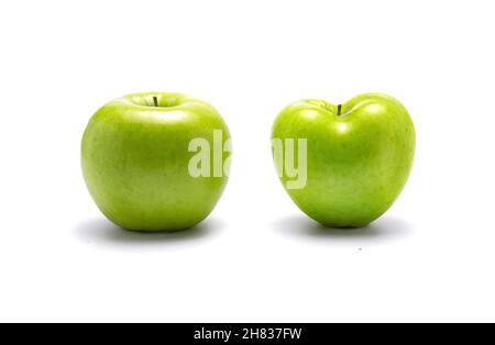 Two green apples, one heart shaped. On white background with dropped shadow. Stock Photo