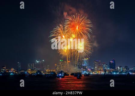 fantastic and colorful fireworks display over the night sky of the city during a festival Stock Photo