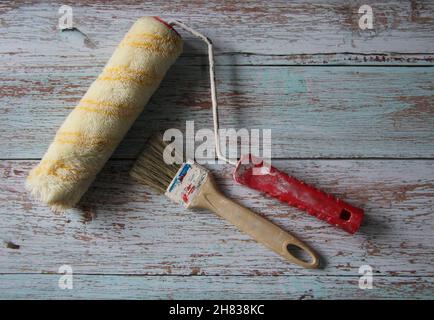 Two different types of paint brushes on an old wooden table. Stock Photo