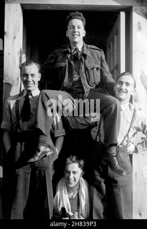 22nd March 1944. LAC Browne held aloft outside barracks at CFB Picton Bombing and Gunnery School (B&GS), Ontario, Canada. He was celebrating passing the RCAF's AB Initio Bombing Course. Final exams were on 17th March, followed by a 48 hour pass to Toronto. Final results were on 22nd. Next stop was No.9 Air Observers' School, St. John, Quebec. Stock Photo