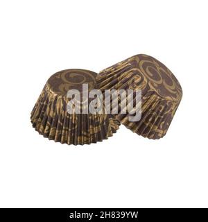 Brown paper baking forms for muffins and cupcakes with golden pattern isolated over white background, object photography Stock Photo