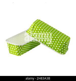Green paper baking forms for cakes with dotted pattern isolated over white background, muffin forms object photography Stock Photo