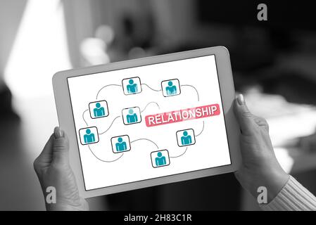 Relationship concept shown on a tablet held by a woman Stock Photo