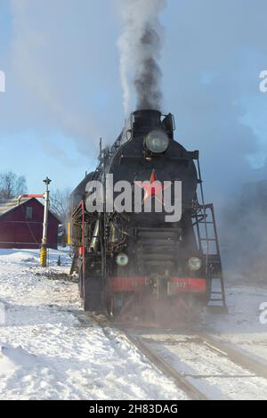 SORTAVALA, RUSSIA - MARCH 10, 2021: Cargo mainline Soviet steam locomotive LV-0522 close-up on a March afternoon. Front view Stock Photo