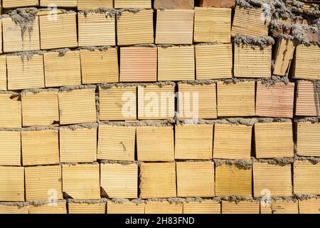 texture or pattern of a yellow break wall, rough placement of breaks Stock Photo