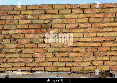 texture or pattern of a yellow break wall, rough placement of breaks Stock Photo