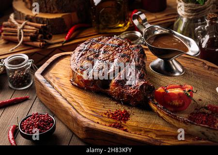 Grilled beef tomahawk steak with pepper sauce Stock Photo