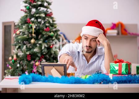 Young man celebrating New year at home alone Stock Photo