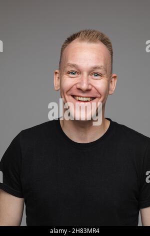 Carefree smiling man in black t-shirt. Stock Photo