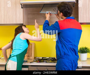 The woman with contractor at kitchen discussing repair Stock Photo