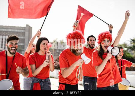 Football fans having fun supporting club on soccer match event at stadium - Sport entertainment concept Stock Photo