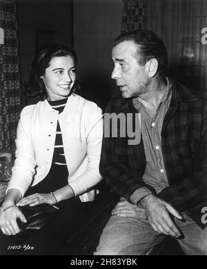 HUMPHREY BOGART with Set Visitor MARISA PAVAN (filming The Rose Tattoo) on set candid during filming of THE DESPERATE HOURS 1955 director WILLIAM WYLER novel / play / screenplay Joseph Hayes cinematographer Lee Garmes costumer Edith Head Paramount Pictures Stock Photo