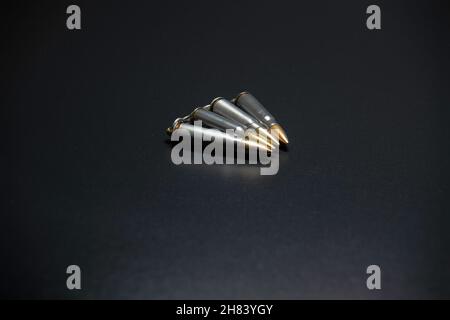 Bullet isolated on black background with reflexion. Rifle bullets close-up on black back Stock Photo