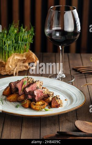 Beef medallions dish with potatoes and mushrooms Stock Photo