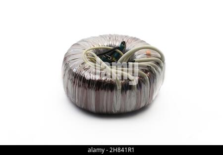 Toroidal transformer isolated on white background. Electronic components and parts. Stock Photo