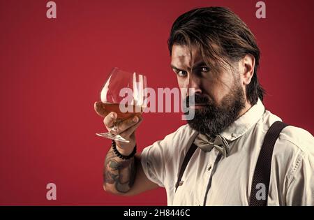 confident bearded man drinking whiskey from glass, bad habit. copy space Stock Photo